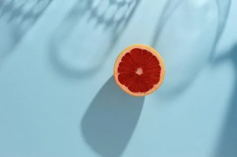 Grapefruit arranged on a bright  blue surface. Stock Photos