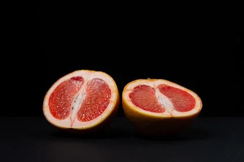 Grapefruit on a black background.  Stock Photos