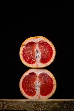 Grapefruit on a black background.  Stock Photos