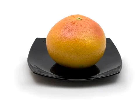 Grapefruit in black dish Stock Photos