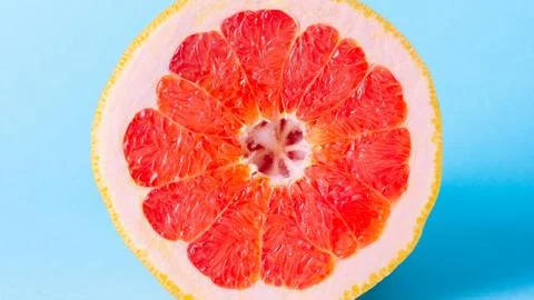 Grapefruit on a blue background. Exotic fruit for diet. Stock Photos