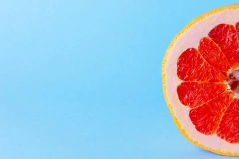 Grapefruit on a blue background. Exotic fruit for diet. Stock Photos