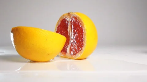 Grapefruit break on two halves on white surface Stock Footage 63081928