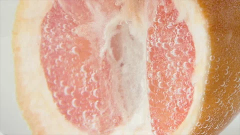 Grapefruit close-up sizzles or floats to the surface. Halves of pink grapefruit Stock Footage 195126692