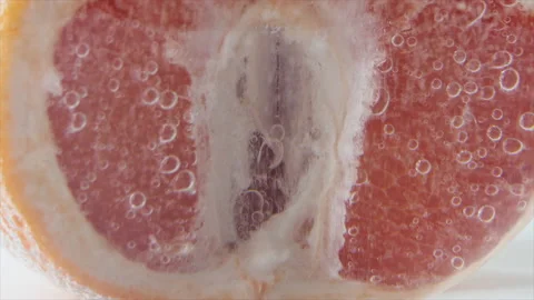 Grapefruit close-up sizzles or floats to the surface. Halves of pink grapefruit Stock Footage 195458789