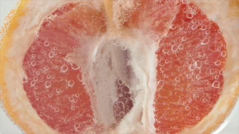 Grapefruit close-up sizzles or floats to the surface. Halves of pink grapefruit Stock Footage 195990200