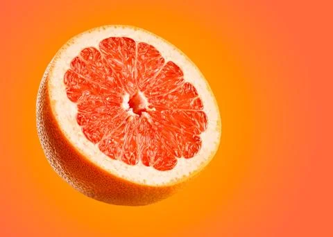 Grapefruit closeup isolated on orange background. Stock Photos