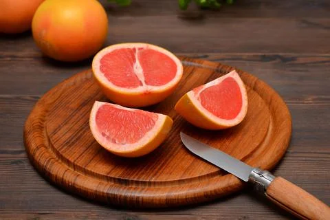 Grapefruit cut on a cutting board on the table Stock Photos