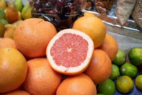 Grapefruit cut in half on top of fruit pile at Alcalde Market in Guadalajara Stock Photos