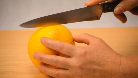 Grapefruit Cut With Sharp Knife Over White Blackground Stock-Footage 89827192