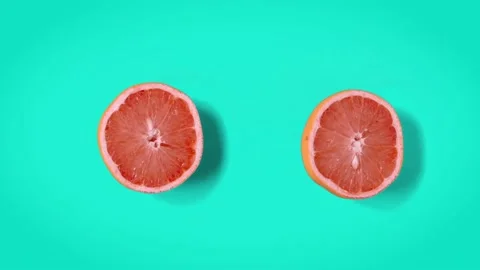 Grapefruit dancing top view. cyan retro background. Stop motion animation. Stock Footage 135417680