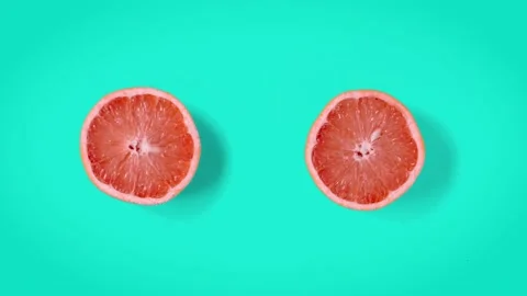 Grapefruit dancing top view. Cyan retro background. Stop motion animation. Stock Footage 135417852