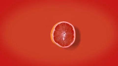 Grapefruit dancing top view. orange retro background. Stop motion animation. Stock Footage 135416582