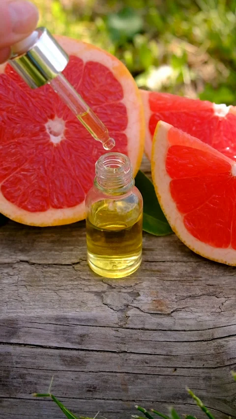 Grapefruit essential oil in a bottle. Selective focus. Stock Footage 313122267