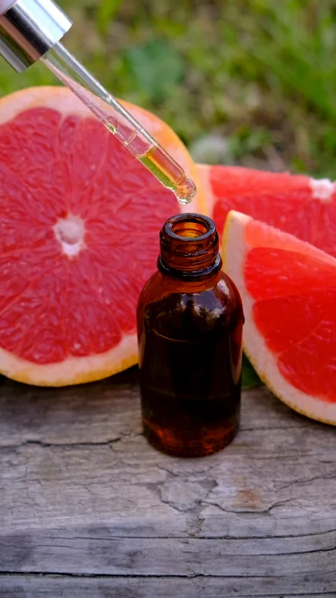 Grapefruit essential oil in a bottle. Selective focus. Stock Footage 314708243