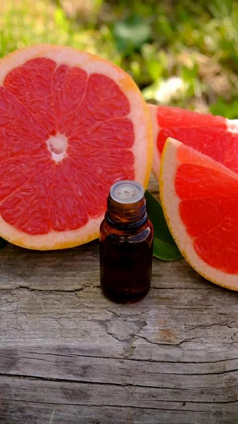 Grapefruit essential oil in a bottle. Selective focus. Stock Footage 315518824
