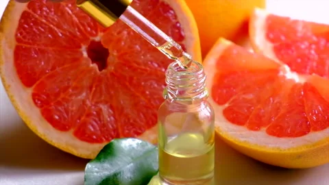 Grapefruit essential oil in a small bottle. Selective focus. Stock Footage 155072591