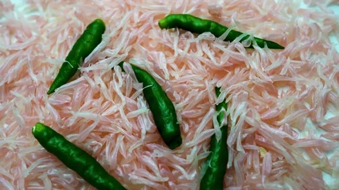 Grapefruit grains and green chilli pepper slide view on white table background Stock Footage 282848369