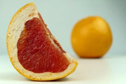 Grapefruit with grapefruit slice isolated on white background close up. Stock Photos