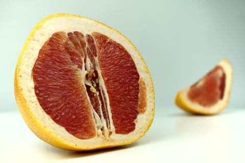 Grapefruit with grapefruit slice isolated on white background close up. Stock Photos