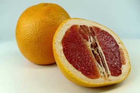 Grapefruit with grapefruit slice isolated on white background close up. Stock Photos