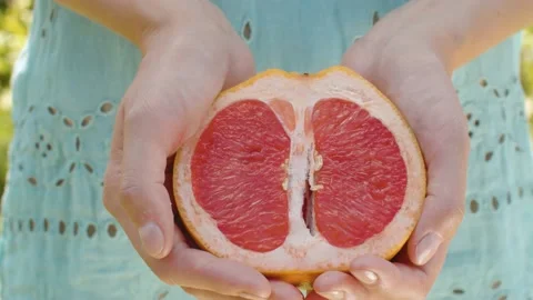 Grapefruit half in female hands Stock Footage 139650329