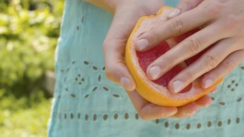 Grapefruit half in female hands Stock Footage 139650500