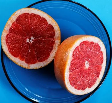 Grapefruit halves close-up on a plate Stock Photos