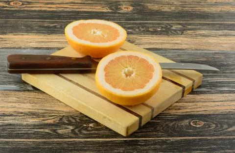 Grapefruit halves on cutting board Stock Photos