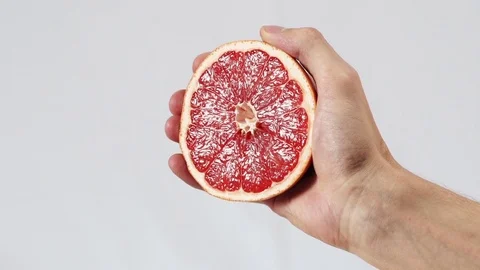 Grapefruit, hand holding half of a gratefruit Stock Footage 72239465