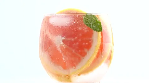 Grapefruit lemonade rotating on light blue background. Fruit grapefruit cocktail Stock Footage 251803176