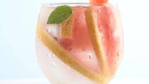 Grapefruit lemonade on white background. Fruit grapefruit cocktail close-up.. Stock Footage 251803167