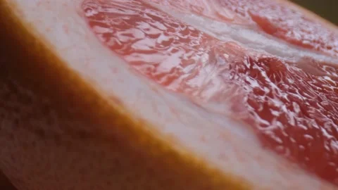 Grapefruit macro shooting,isolated half grapefruit on yellow background rotates Stock Footage 130997127
