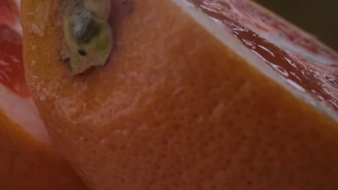 Grapefruit macro shooting,isolated half grapefruit on yellow background rotates Stock Footage 131610509