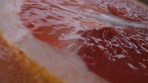 Grapefruit macro shooting,isolated half grapefruit on yellow background rotates Stock Footage 131610810