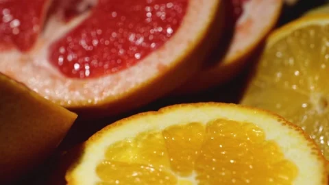 Grapefruit, oranges and lemon sliced on a bamboo board Stock Footage 146146384