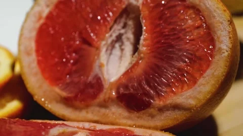 Grapefruit, oranges, lemon and pineapple sliced on a bamboo board Stock Footage 146146658
