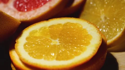 Grapefruit, oranges, lemon and pineapple sliced on a bamboo board Stock Footage 146146781