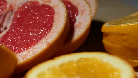 Grapefruit, oranges, lemon and pineapple sliced on a bamboo board Stock Footage 146147266