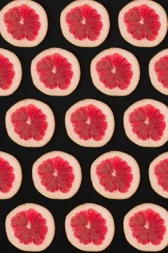 Grapefruit pattern isolated on black background. Flat lay Stock Photos