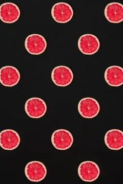 Grapefruit pattern isolated on black background. Flat lay Stock Photos