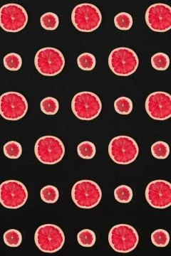 Grapefruit pattern isolated on black background. Flat lay Stock Photos
