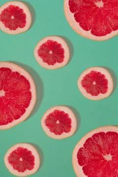 Grapefruit pattern isolated on blue background. Flat lay Stock Photos