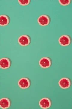 Grapefruit pattern isolated on blue background. Flat lay Stock Photos
