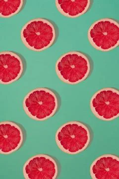 Grapefruit pattern isolated on blue background. Flat lay Stock Photos