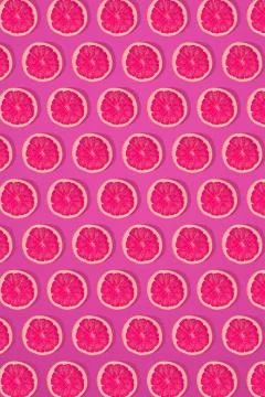 Grapefruit pattern on pink background. Minimal flat lay concept. Stock Photos