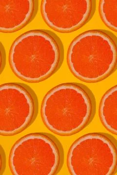 Grapefruit pattern on yellow background. Minimal flat lay concept. Stock Photos