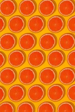 Grapefruit pattern on yellow background. Minimal flat lay concept. Stock Photos
