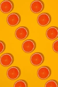 Grapefruit pattern on yellow background. Minimal flat lay concept. Stock Photos