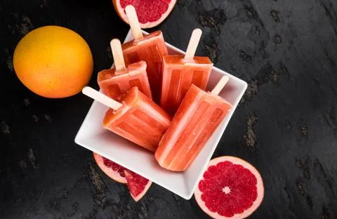Grapefruit Popsicles (selective focus) on a vintage background Stock Photos
